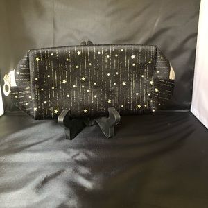 Falling‎ gold stars makeup bag or clutch. Black in color.